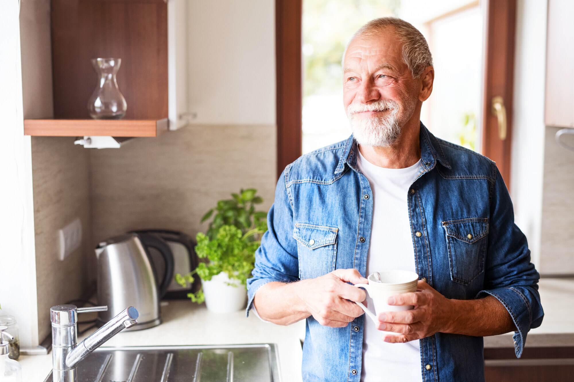 Happy-senior-man-holding-a-cup